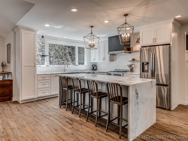 kitchen featuring white cabinets, stainless steel appliances, and a center island