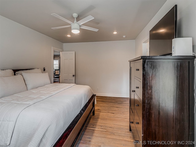 bedroom featuring ceiling fan and light hardwood / wood-style flooring