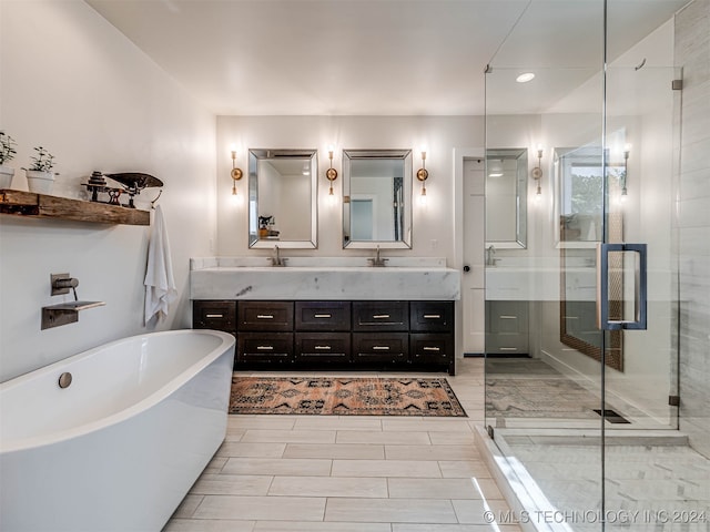 bathroom with vanity and separate shower and tub