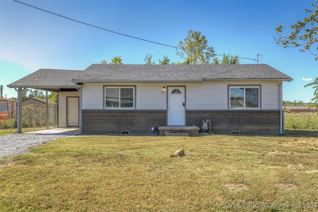 ranch-style home with a front yard and a carport