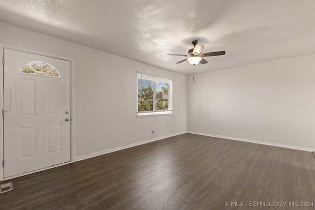 entrance foyer with a wealth of natural light, ceiling fan, and dark hardwood / wood-style floors