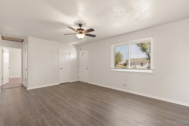 spare room featuring ceiling fan, a textured ceiling, and dark hardwood / wood-style floors