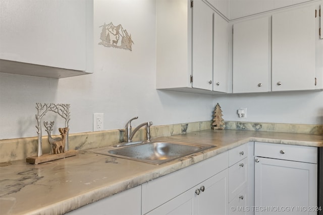 kitchen with sink and white cabinetry