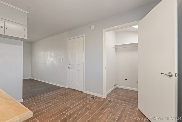 washroom featuring hookup for an electric dryer and dark hardwood / wood-style floors