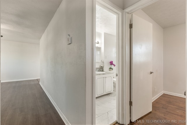 corridor with wood-type flooring