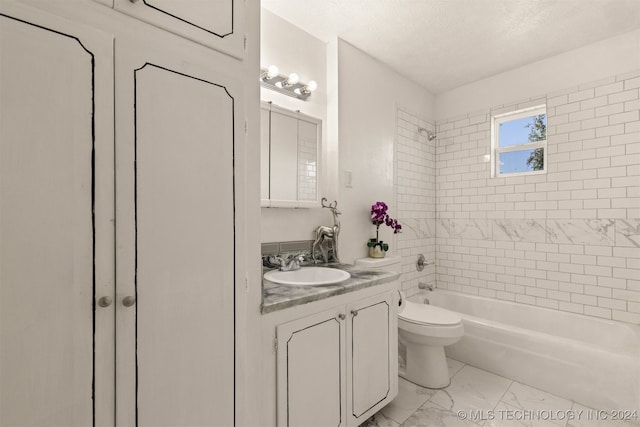 full bathroom with a textured ceiling, tiled shower / bath combo, vanity, and toilet