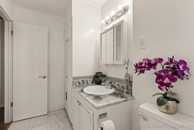 bathroom featuring vanity and toilet