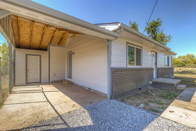 doorway to property featuring a carport