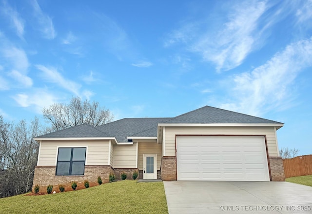 view of front of house featuring a garage and a front yard