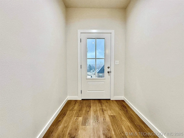 doorway to outside with light wood-type flooring