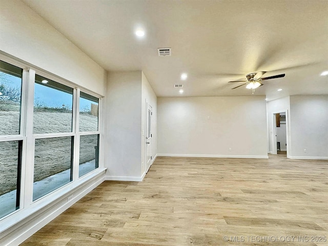 unfurnished room with ceiling fan and light hardwood / wood-style flooring