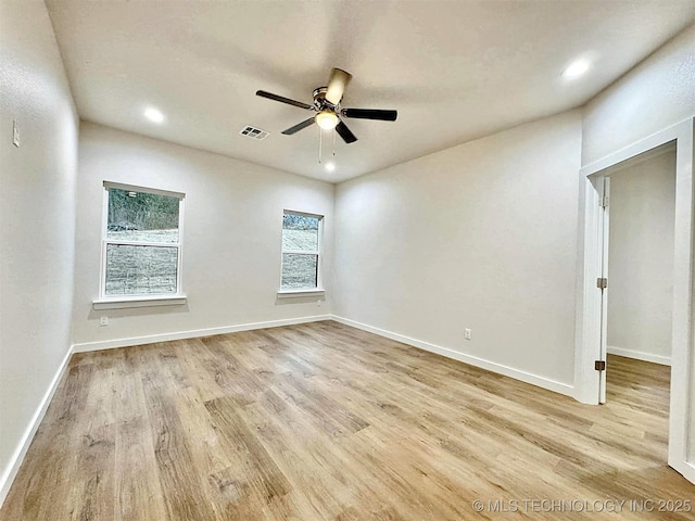 empty room with ceiling fan and light wood-type flooring