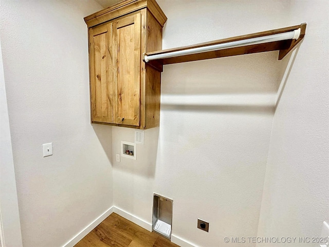 laundry area featuring washer hookup, cabinets, hardwood / wood-style flooring, and hookup for an electric dryer