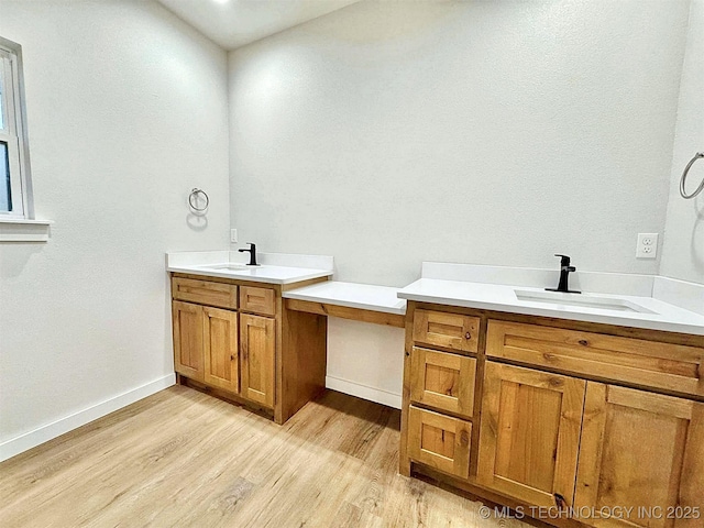 bathroom with hardwood / wood-style flooring and vanity