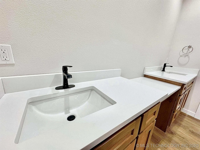 bathroom featuring hardwood / wood-style flooring and vanity