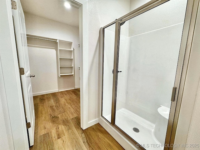 bathroom featuring hardwood / wood-style flooring and an enclosed shower