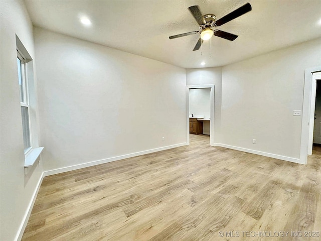 spare room featuring ceiling fan and light hardwood / wood-style flooring