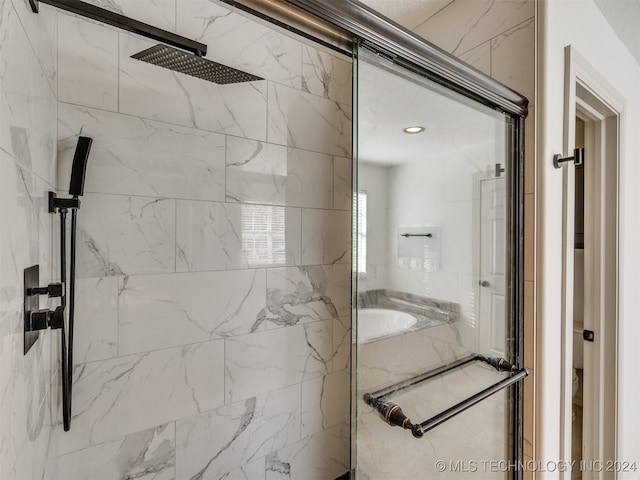 bathroom featuring a shower with door