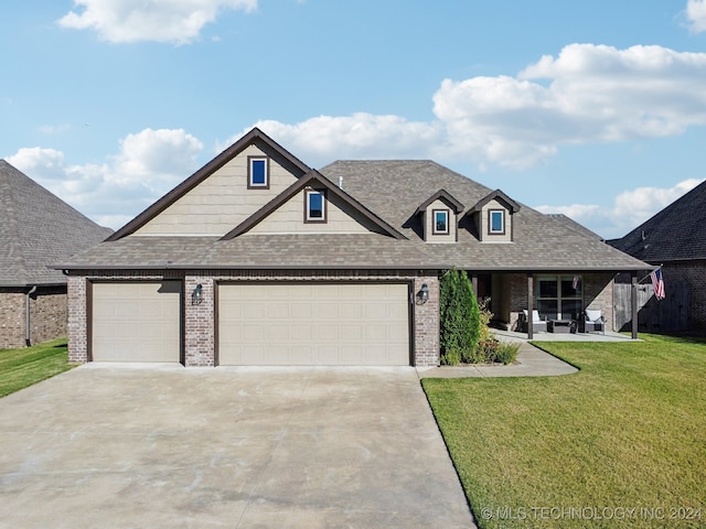 view of front of home with a garage and a front lawn