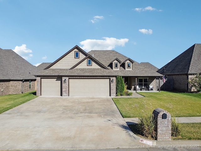 view of front of home with a front yard and a garage