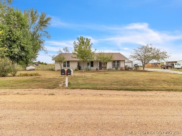 single story home featuring a front lawn