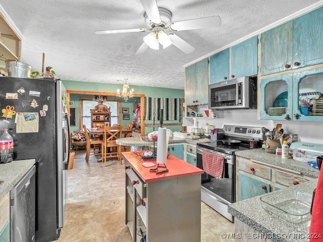 kitchen featuring a textured ceiling, stainless steel appliances, and a kitchen island