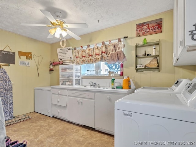 laundry area featuring a textured ceiling, washing machine and dryer, ceiling fan, and cabinets