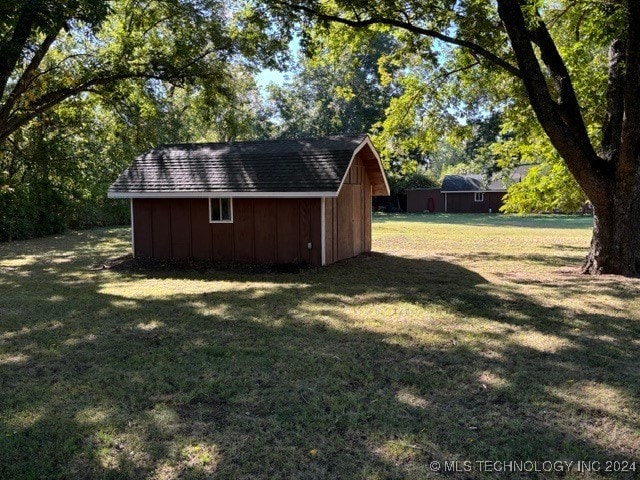 view of outbuilding with a lawn