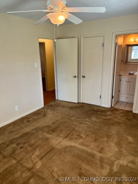 unfurnished bedroom with light carpet, connected bathroom, and ceiling fan