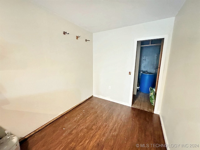 unfurnished room with dark hardwood / wood-style floors