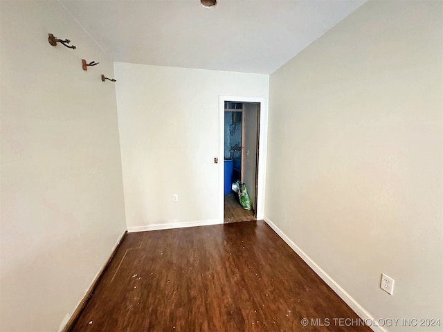 unfurnished room with dark hardwood / wood-style flooring