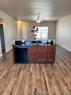 kitchen featuring dishwasher and dark wood-type flooring