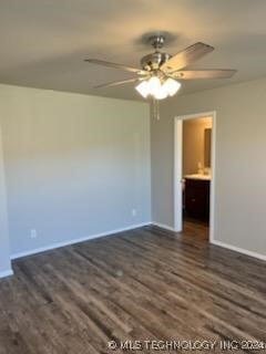 spare room with dark hardwood / wood-style floors and ceiling fan