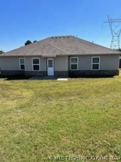 back of house with a lawn