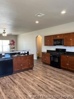 kitchen featuring black appliances, ceiling fan, and light hardwood / wood-style floors