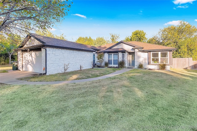 ranch-style home with a garage and a front yard