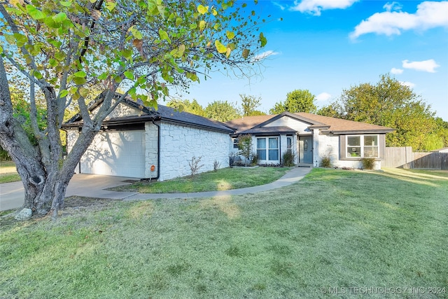 single story home featuring a front yard and a garage