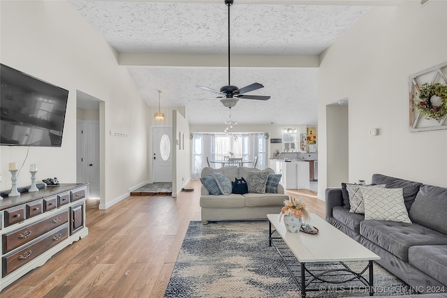 living room with a textured ceiling, hardwood / wood-style floors, and ceiling fan