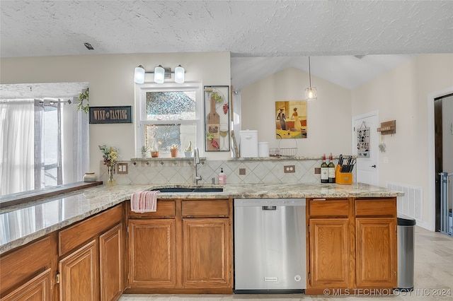 kitchen with lofted ceiling, sink, tasteful backsplash, stainless steel dishwasher, and a textured ceiling