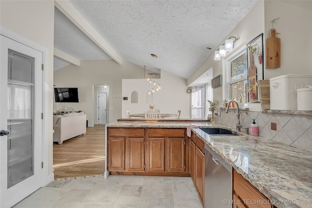 kitchen featuring hanging light fixtures, sink, dishwasher, lofted ceiling with beams, and light hardwood / wood-style floors