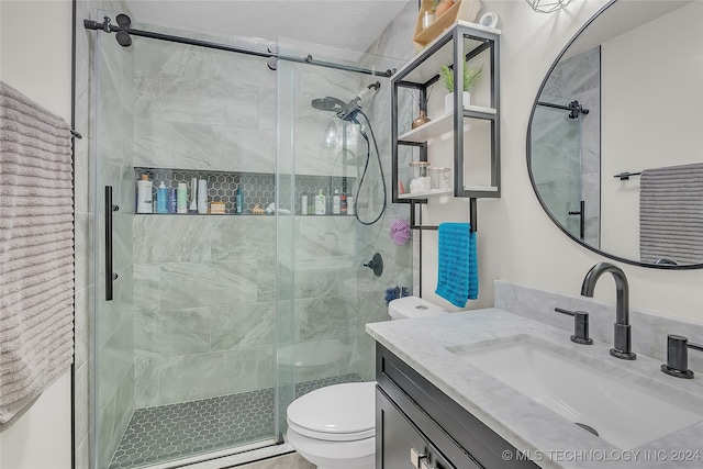 bathroom featuring vanity, toilet, and a shower with door