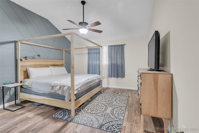 bedroom featuring wood-type flooring, lofted ceiling, and ceiling fan