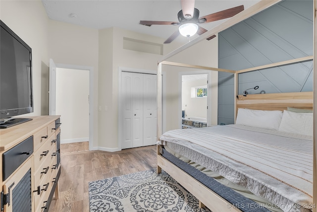 bedroom with light hardwood / wood-style floors, ceiling fan, and a closet