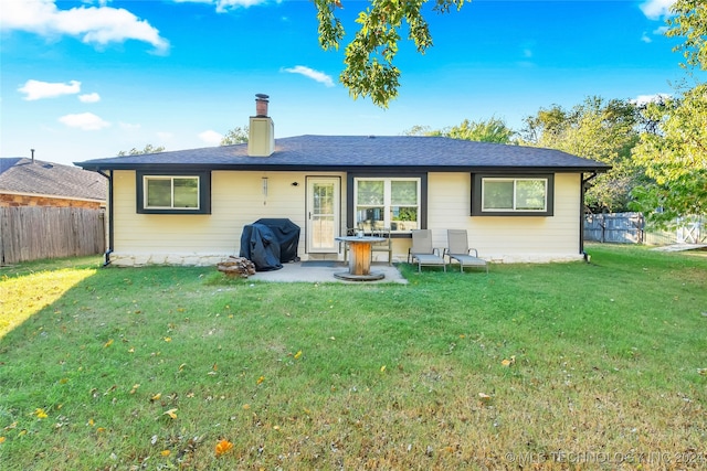 back of house with a patio and a yard