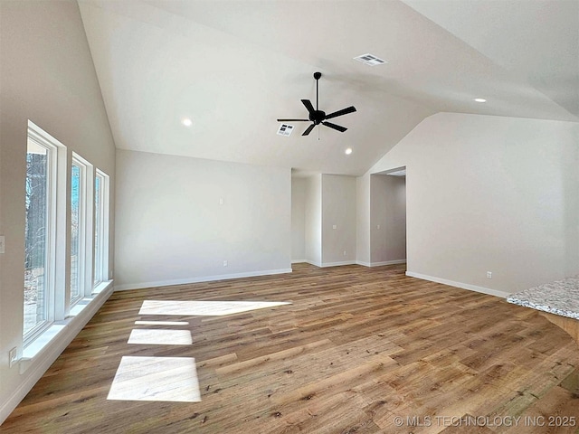 unfurnished room featuring wood finished floors, visible vents, and baseboards