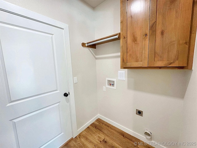 laundry area featuring cabinet space, baseboards, hookup for a washing machine, hookup for an electric dryer, and light wood-style floors