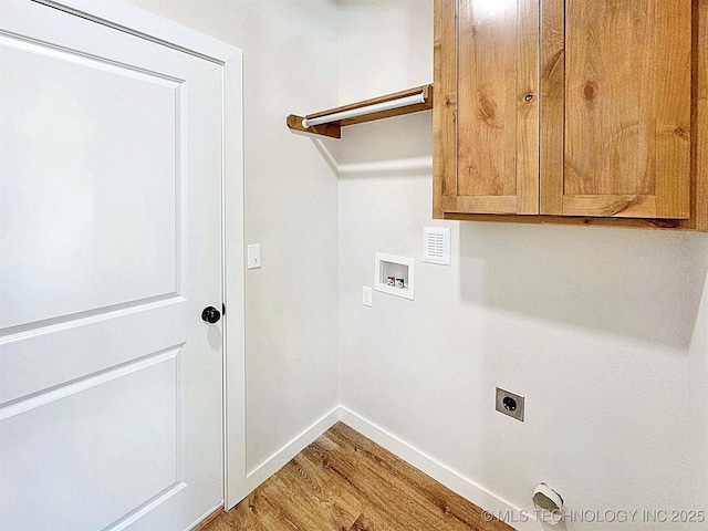 856 E Harlan Dr, Tahlequah, OK 74464 - washroom with hookup for a washing machine, hookup for an electric dryer, light wood-type flooring, baseboards, and cabinet space