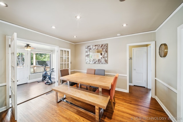 dining room featuring wood-type flooring, crown molding, ceiling fan, and french doors