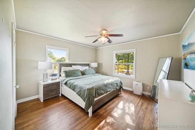 bedroom featuring ceiling fan, crown molding, hardwood / wood-style floors, and multiple windows