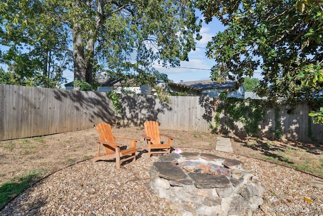 view of yard with a fire pit